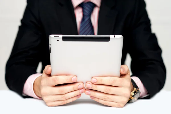 Businessman's hands holding portable device