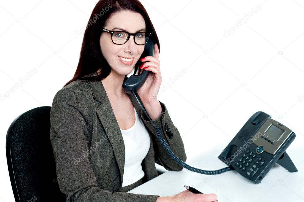 Young businesswoman holding phone receiver