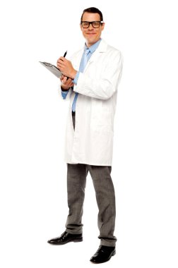 Young physician writing medical report clipart