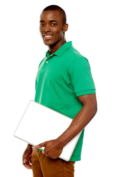Casual teenager carrying laptop — Stock Photo, Image