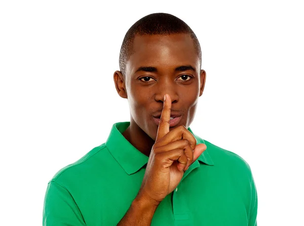 Young african guy showing silence gesture — Stock Photo, Image