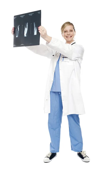 Cheerful female doctor holding x-ray report — Stock Photo, Image