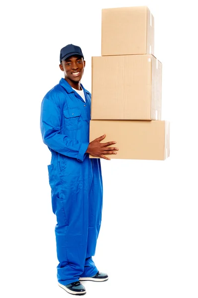 Young delivery boy holding cardboard boxes — Stock Photo, Image