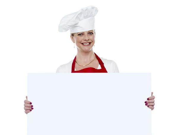 Matured cook presenting blank billboard — Stock Photo, Image