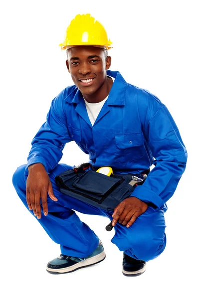 Seated african worker posing with a smile — Stock Photo, Image