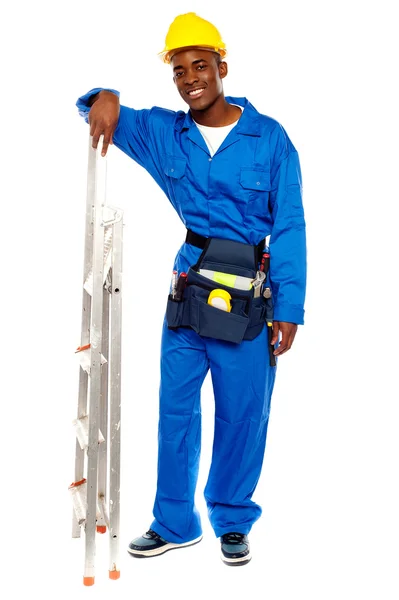 Smiling african worker resting hand on stepladder — Stock Photo, Image