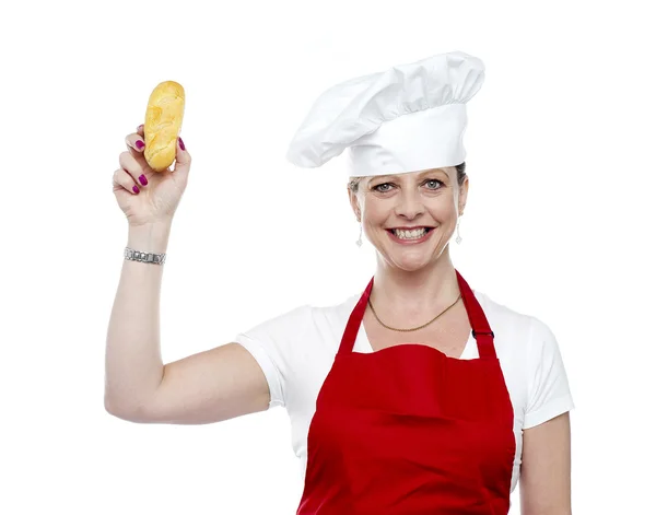 Female chef showing bread before baking it — Stock Photo, Image