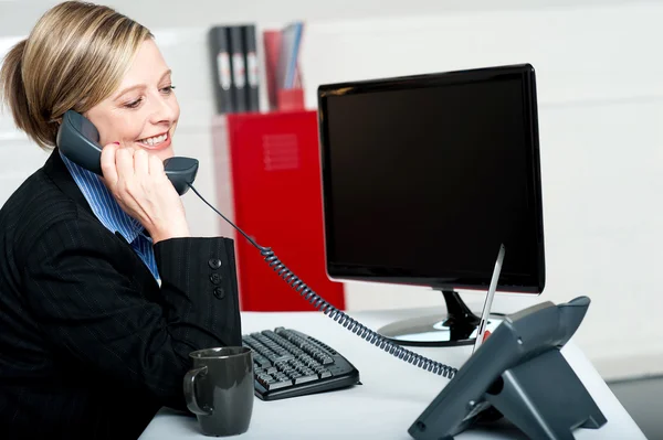 Female secretary answering bosses call — Stock Photo, Image