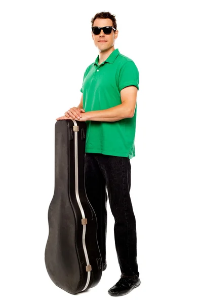 Trendy young man posing with guitar case — Stock Photo, Image