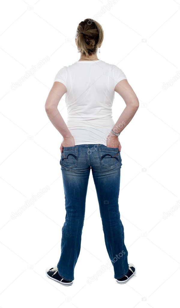 Back view of trendy woman with hands in pocket