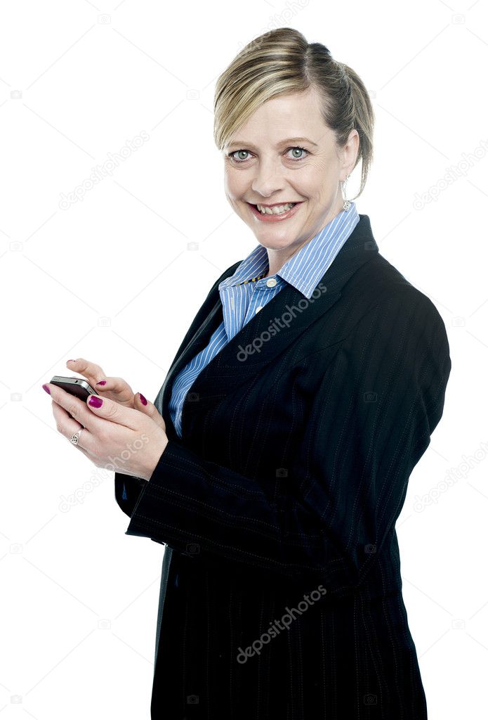 Smiling corporate lady using cellphone