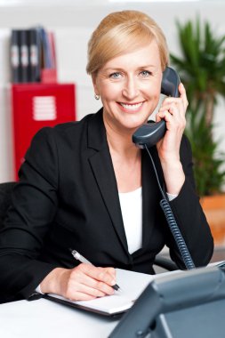 Corporate lady communicating on phone clipart