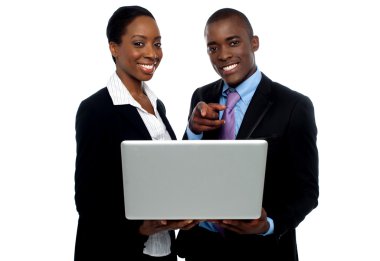 African coworkers operating laptop and pointing clipart