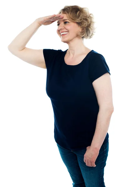 Lady looking for someone with hand on forehead — Stock Photo, Image