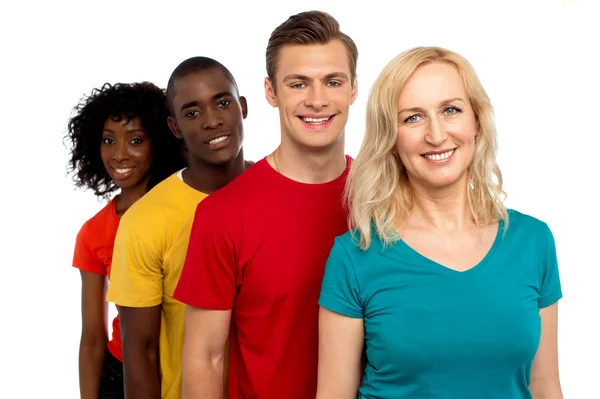 Group of cheerful teenagers standing in a line — Stock Photo, Image