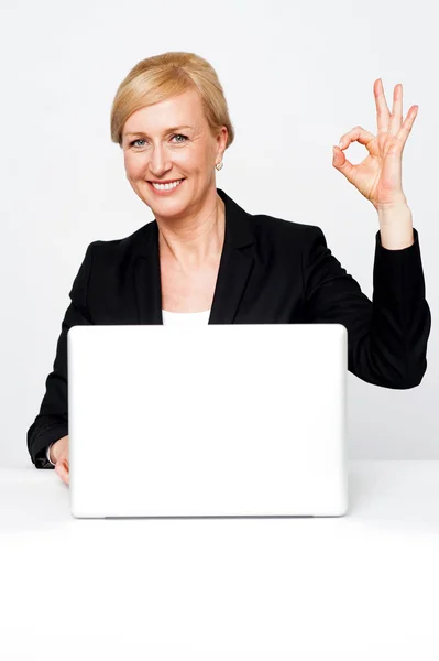 Happy businesswoman gesturing okay sign — Stock Photo, Image
