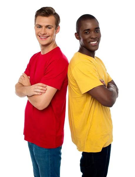 Friends posing back to back with arms crossed — Stock Photo, Image