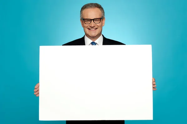 Business representative holding blank ad board — Stock Photo, Image