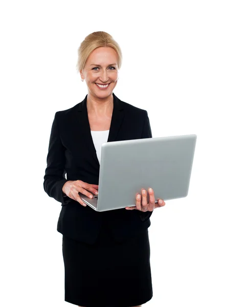 Corporate woman holding laptop — Stock Photo, Image