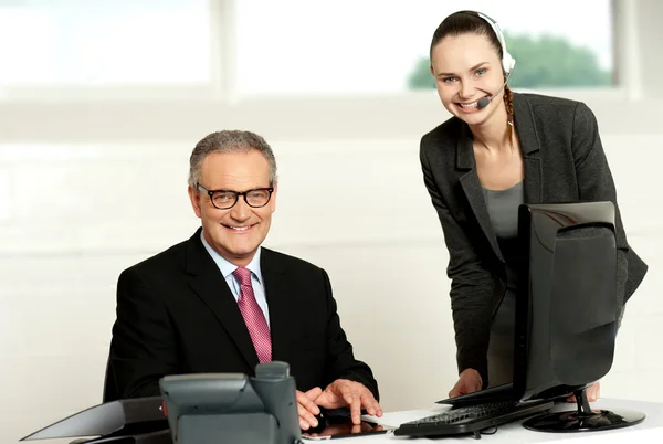 Successful team of senior man and young woman — Stock Photo, Image