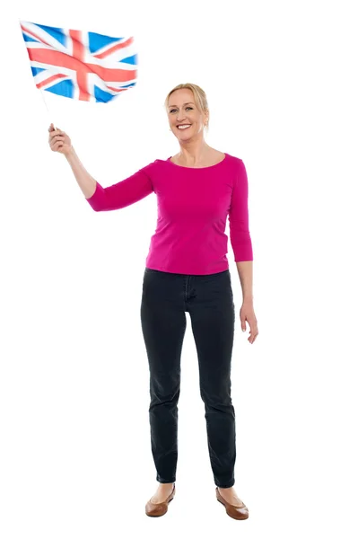 Aged patriotic lady waving United Kingdom flag — Stock Photo, Image