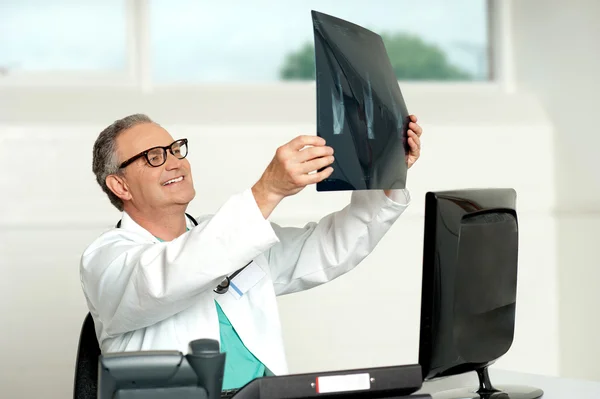 Chefchirurg mit Brille blickt auf Röntgenbild — Stockfoto