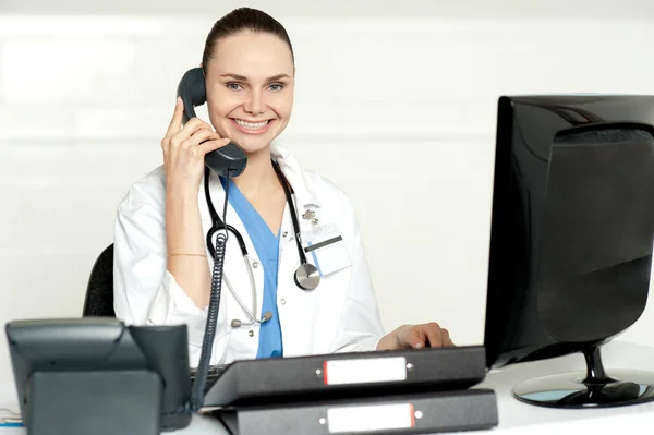 Young smiling physician sitting in clinic — Stock Photo, Image