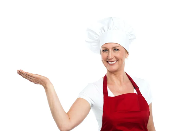 Smiling senior cook showing copy space — Stock Photo, Image