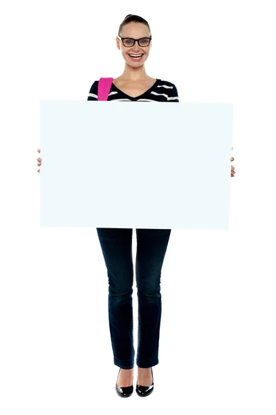 Chica de la universidad sosteniendo el tablero del anuncio blanco, tiro de cuerpo entero — Foto de Stock