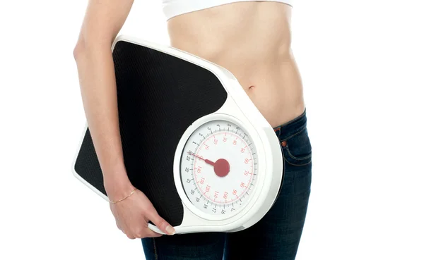 Closeup shot, woman carrying weighing machine — Stock Photo, Image