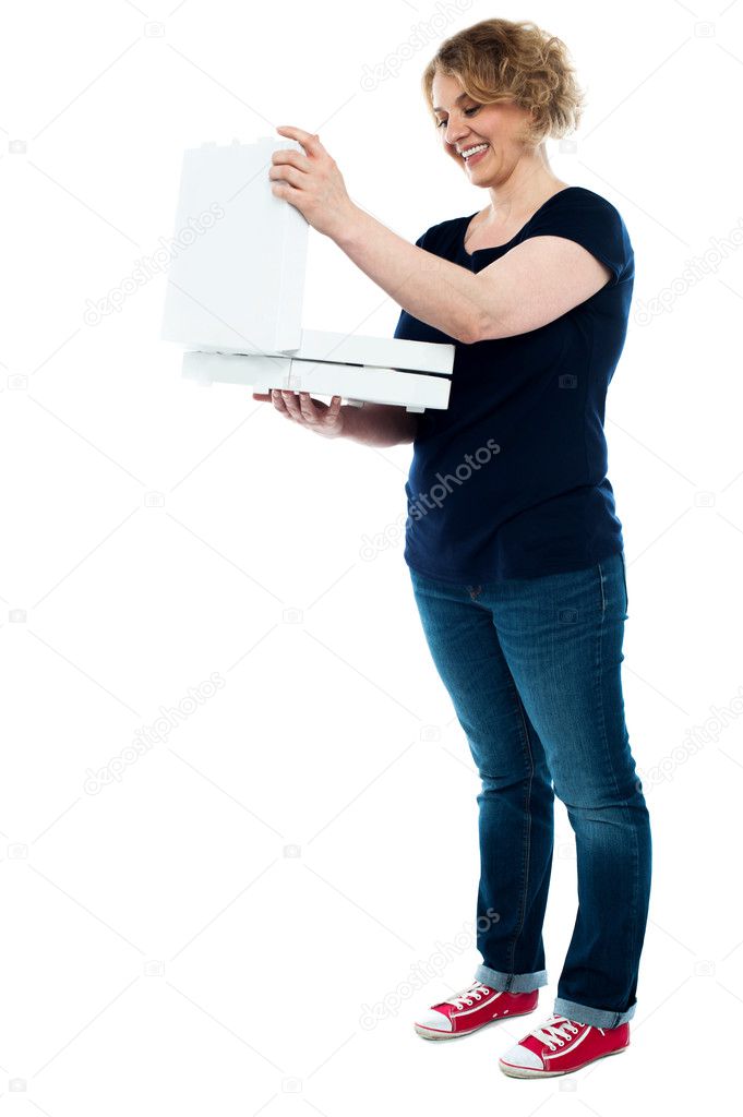 Beautiful woman looking into pizza box