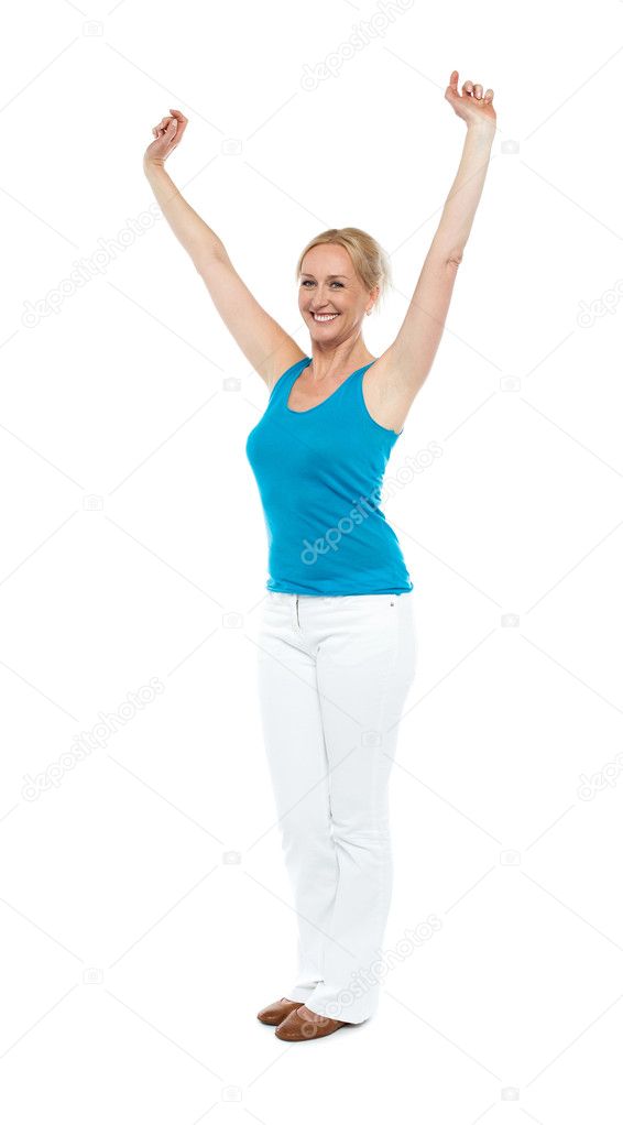 Successful woman posing with raised arms