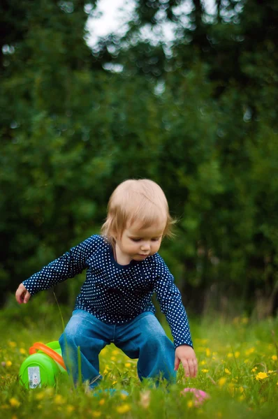 stock image Little girl picks up a fallen toy