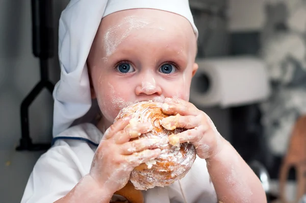 Porträt eines kleinen Jungen, der einen Bagel isst — Stockfoto
