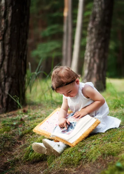 stock image Little girl watching a family photo album