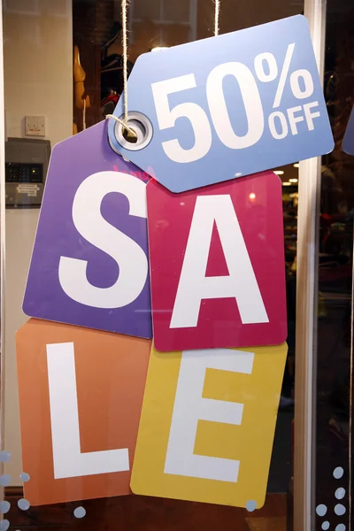 Sale signs in shop window — Stock Photo, Image