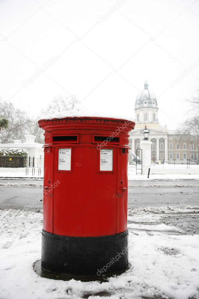 Snow covered traditional british post box