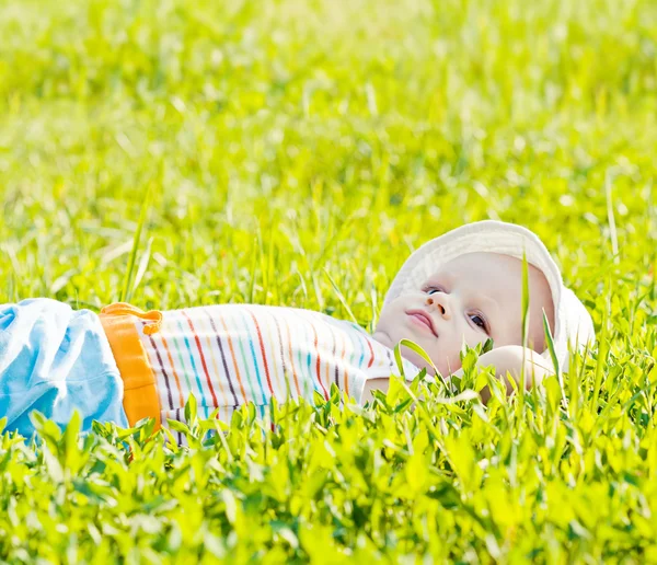 Pequeño bebé soñando tendido en la hierba — Foto de Stock