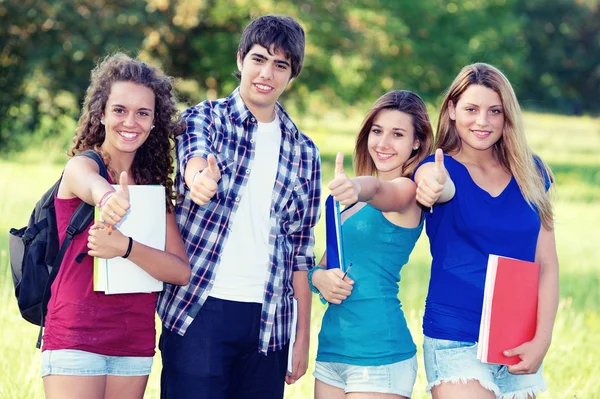 Jovem grupo de estudantes felizes mostrando polegares para cima assinar juntos — Fotografia de Stock