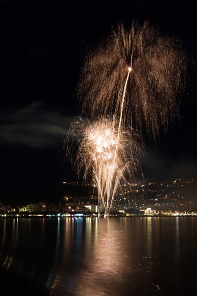 The Night fireworks on the beach near town — Stock Photo, Image