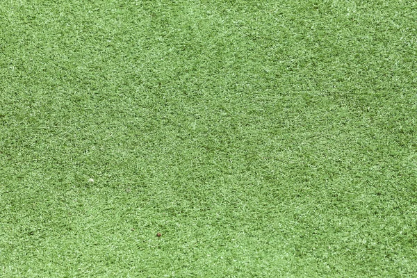 Зелений пластиковий трав'яний поле текстури вид зверху — стокове фото