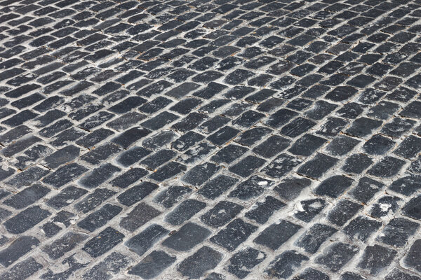 Vintage stone paved avenue street road in old town in Europe