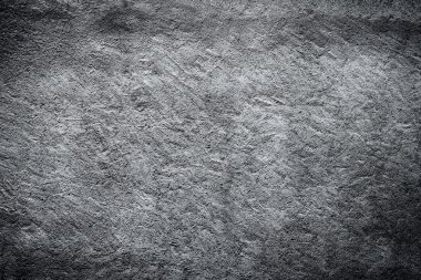 Dark edged black and white plaster concrete wall background. clipart