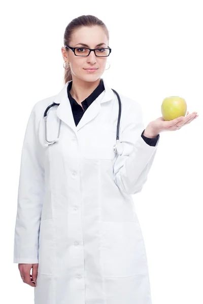 Een arts met een stethoscoop en apple. — Stockfoto