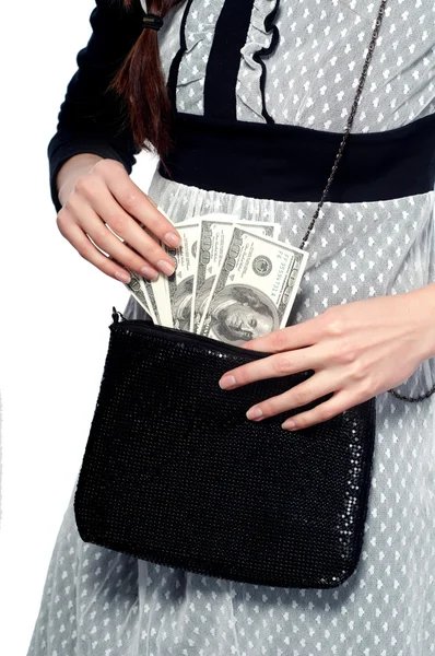 Uma jovem tira dólares do saco. Em um fundo branco — Fotografia de Stock