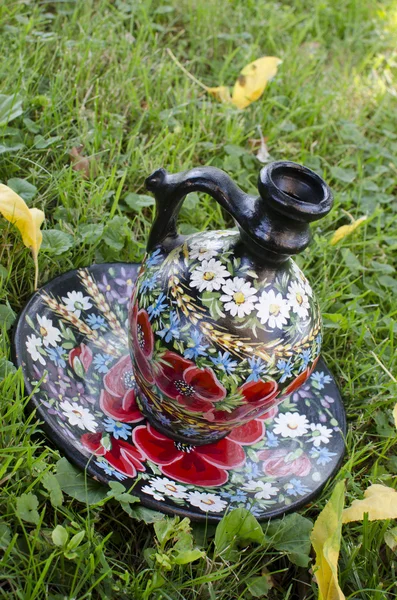 Antique jug with flowers — Stock Photo, Image