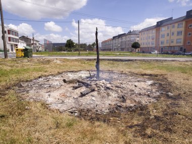 Ashes of a bonfire in an urban environment clipart