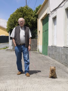 Elderly man walking a dog clipart