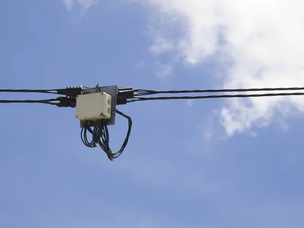 Elektrisk transformator på en kabel och himmel bakgrund — Stockfoto
