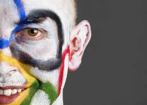Olympic rings painted on the face of smiling man — Stock Photo, Image